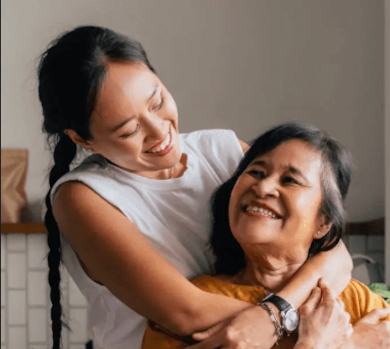 Daughter embracing her mother from behind, showing loving support and care